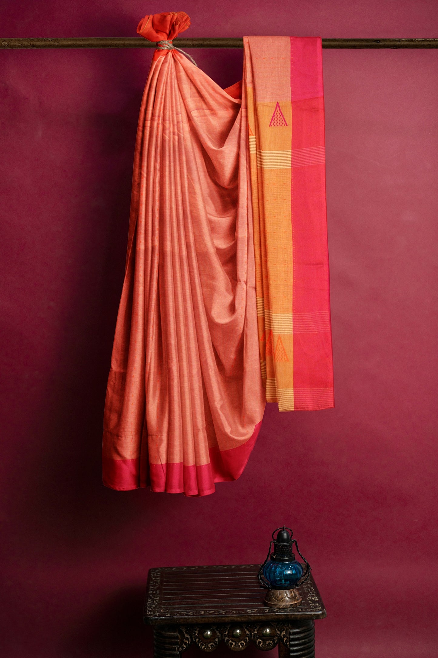 A red orange and pink saree