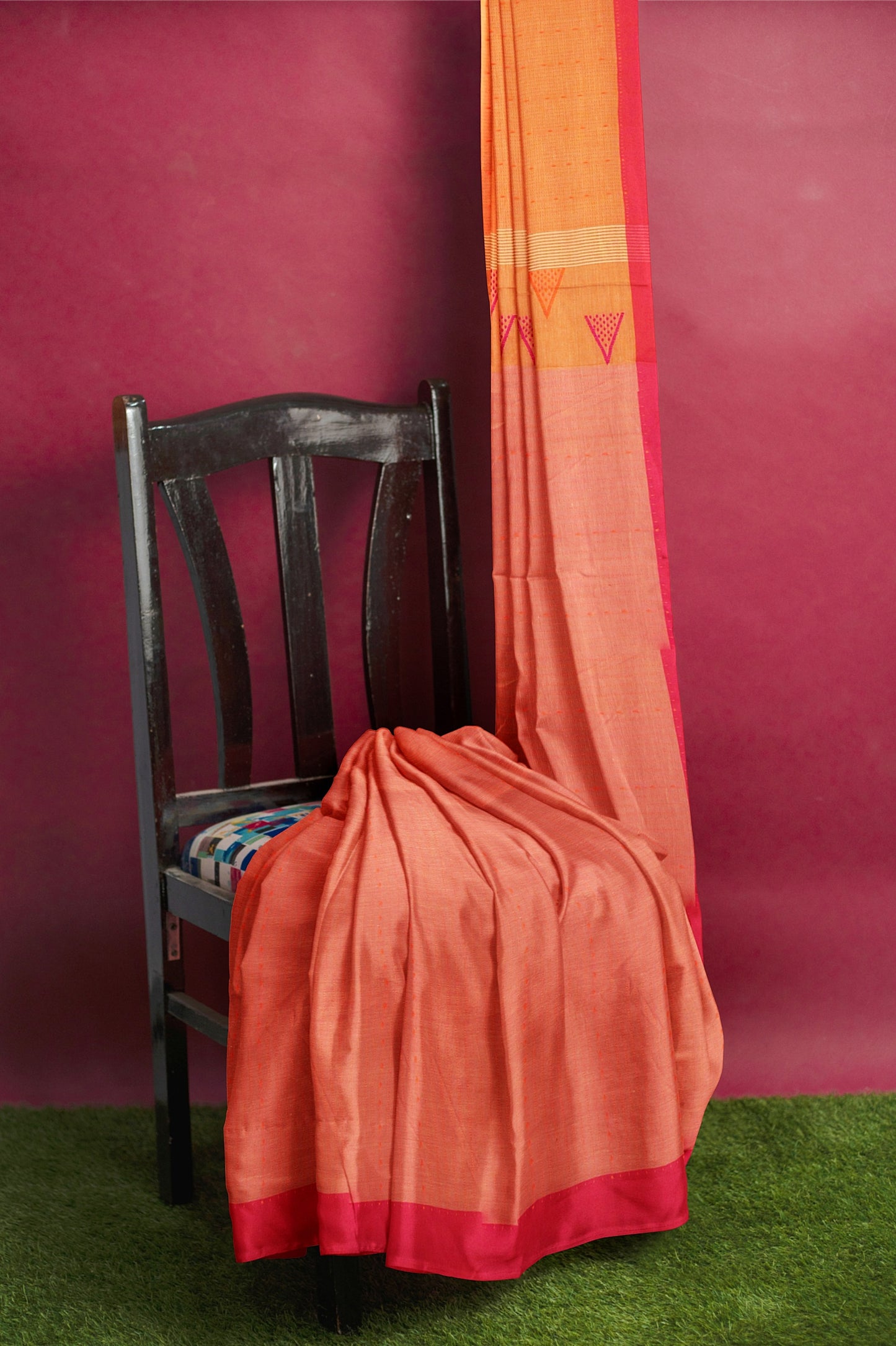 A red orange and pink saree