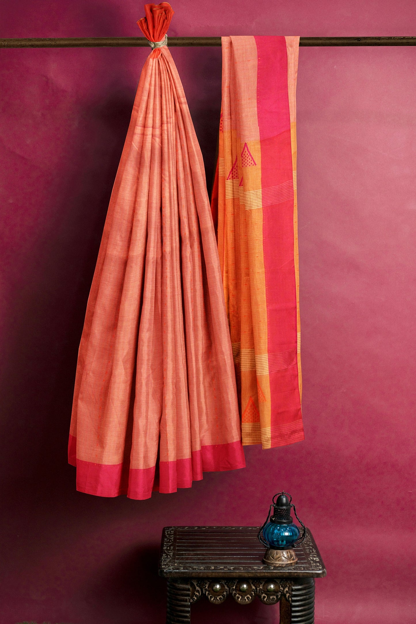 A red orange and pink saree