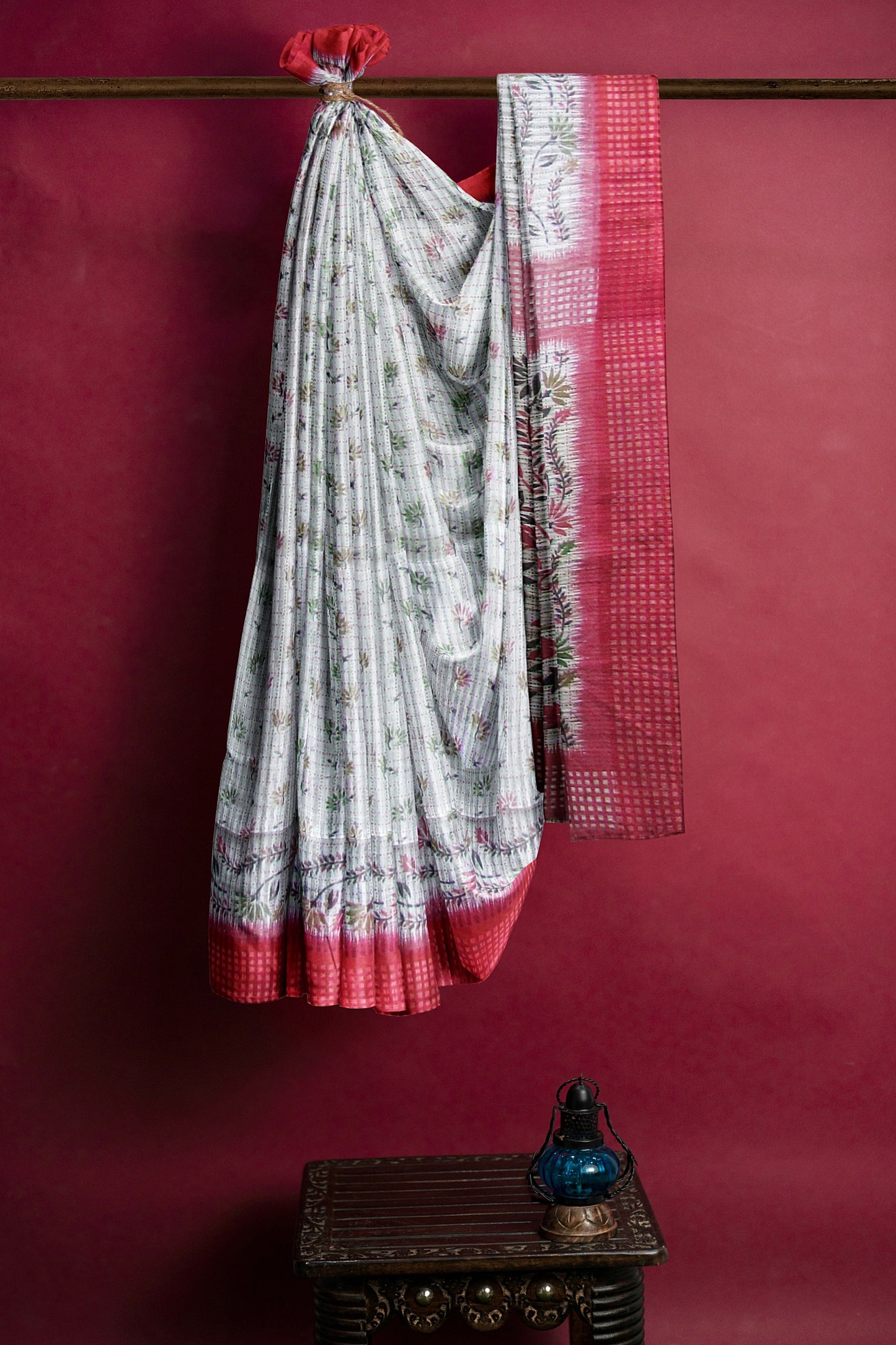 A handloom saree on a grey base and a red border