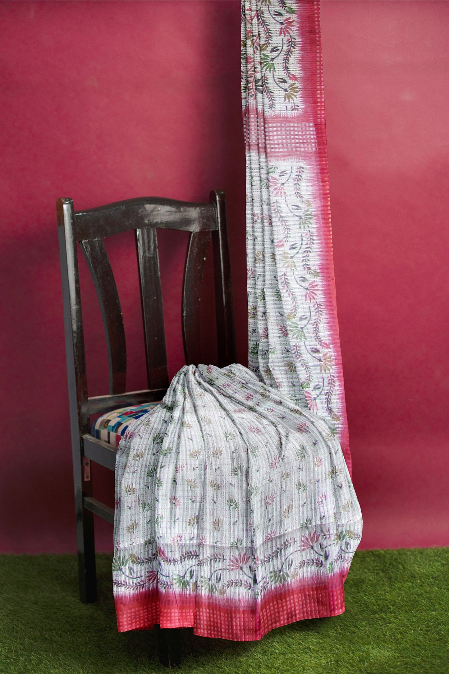 A handloom saree on a grey base and a red border