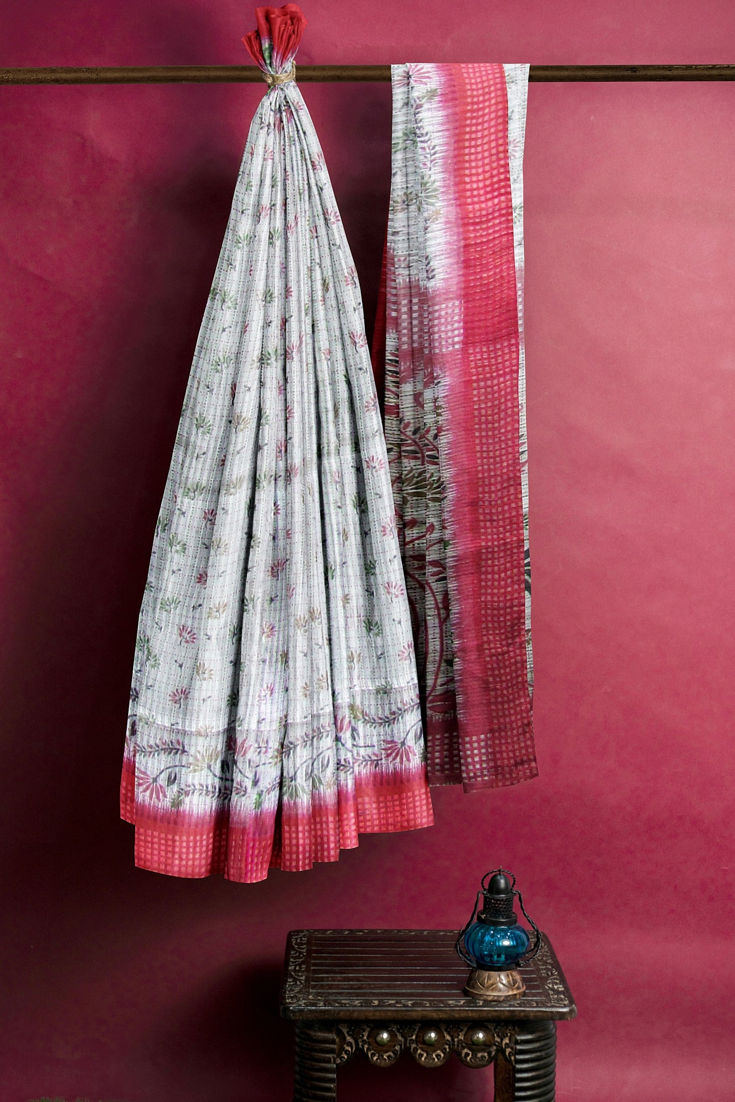 A handloom saree on a grey base and a red border